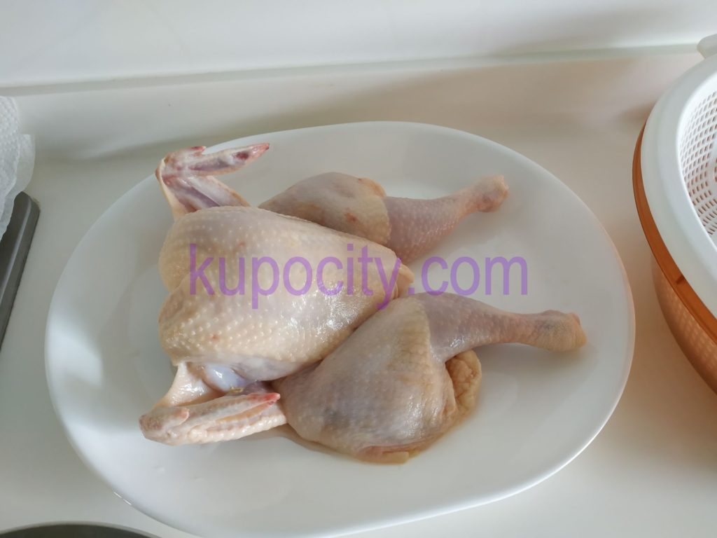 Use Kitchen Scissors to cut away the chicken's back bone, wash and clean whole chicken, lay it flat on plate.