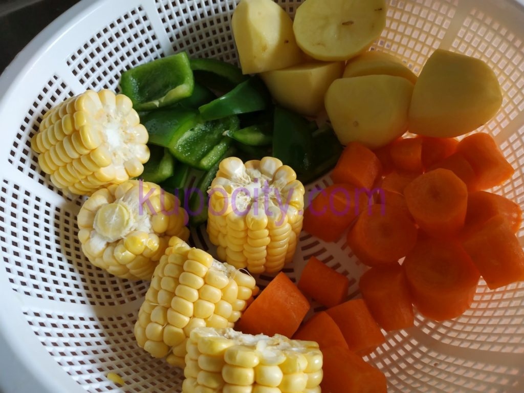 Prepare and chop the corn , carrots , green pepper , potatoes and wash them.