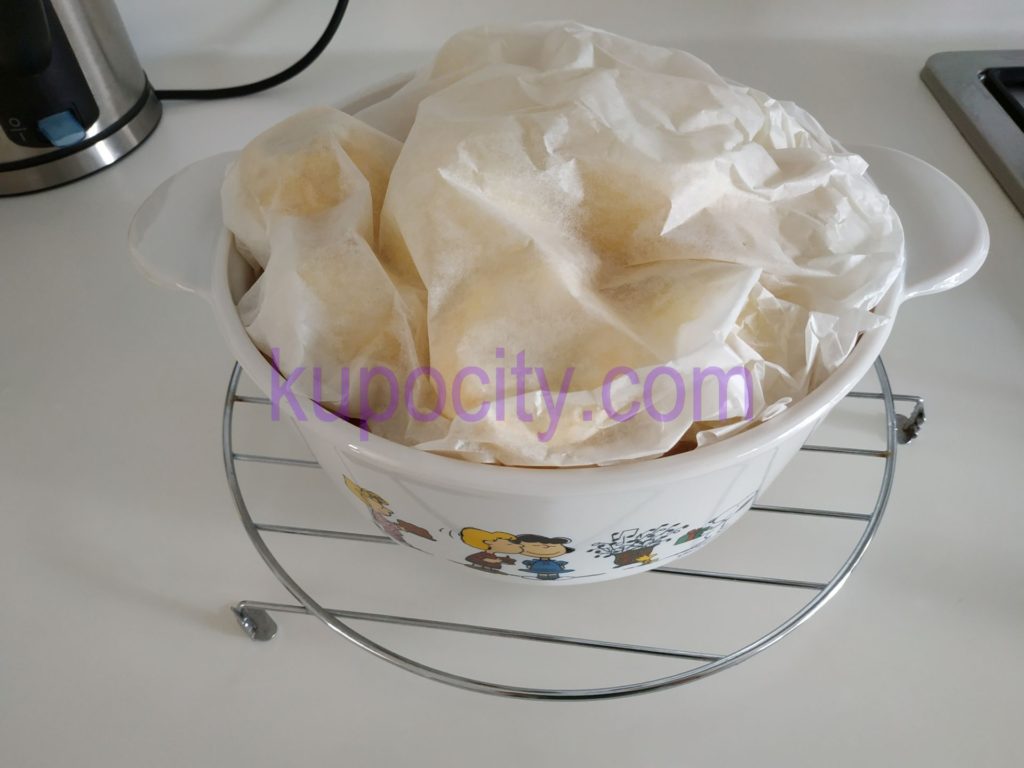 Wrap baking paper on top of dish, this is to protect the moisture from escaping so the food won't dry out in the oven while baking.