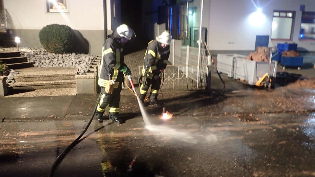 Firefighers use fire torches and hot water to try to melt out the chocolate and wash the chocolate away.