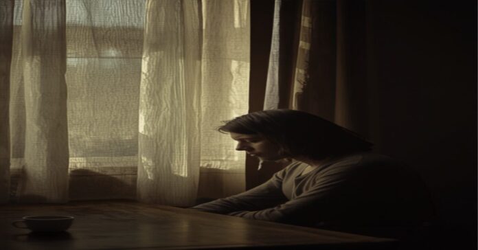 Quiet patience — a woman sitting quietly by a window