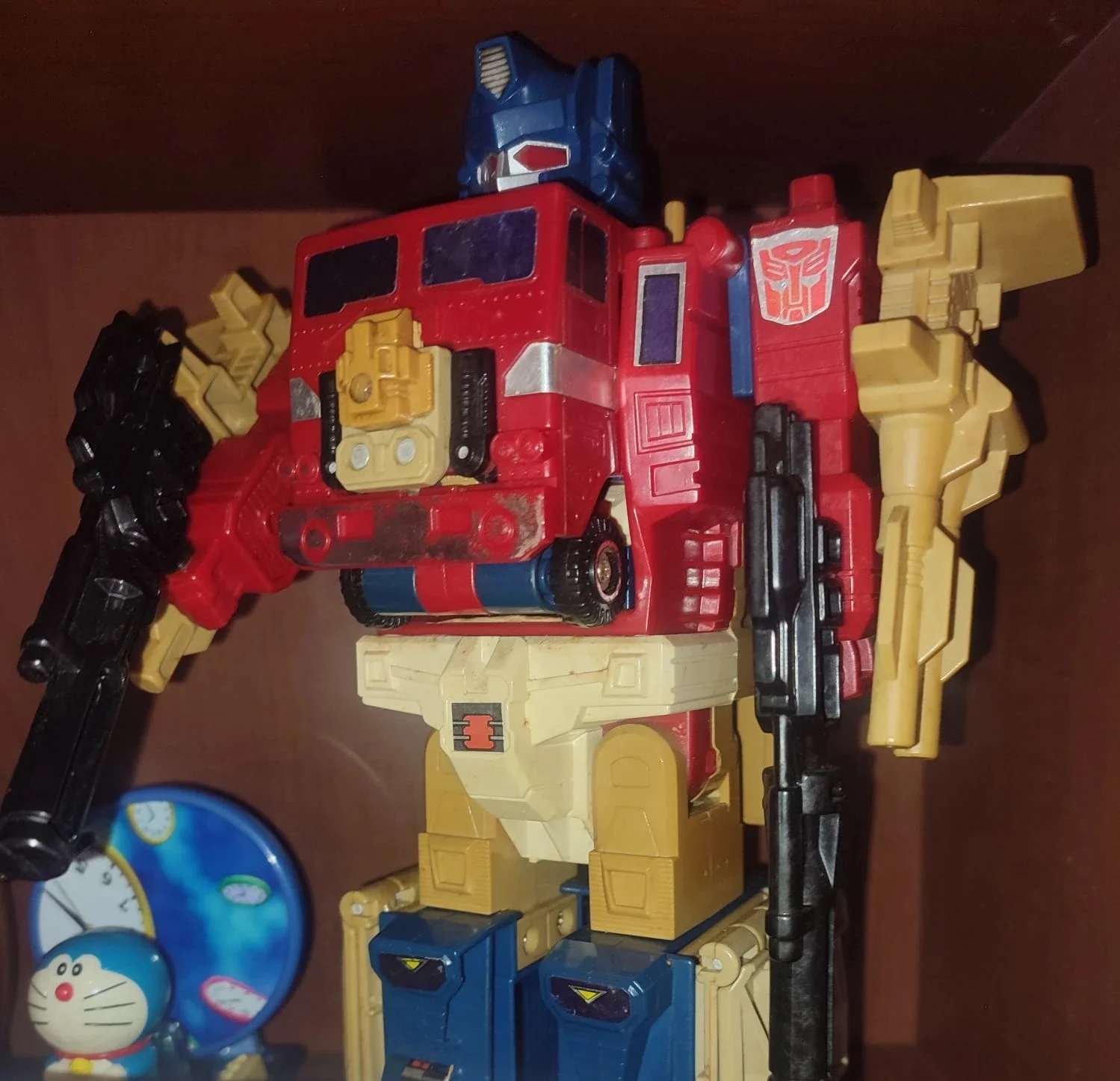 A well-loved vintage G1 Optimus Prime toy figure on a shelf